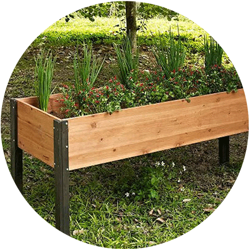 A wooden raised garden bed with metal legs sitting in a yard.